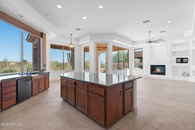 a large kitchen with stainless steel appliances a stove a sink a oven and a refrigerator