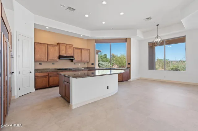 an empty room with windows and fireplace