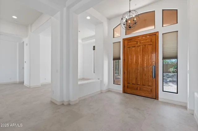 an empty room with windows wooden wall