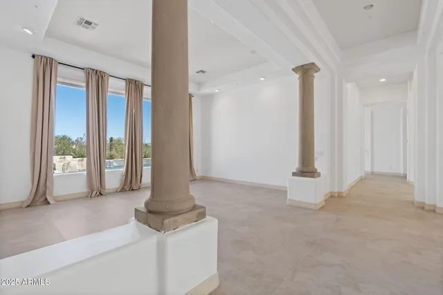 an empty room with windows and closet