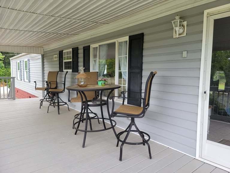 722 Hunt Valley Road Rocky Mount, VA 24151 - Photo 20 of 23 a view of a patio with table and chairs with wooden floor and fence
