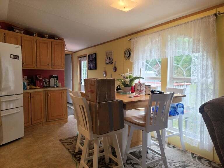 722 Hunt Valley Road Rocky Mount, VA 24151 - Photo 7 of 23 a kitchen with a table chairs refrigerator and dining table