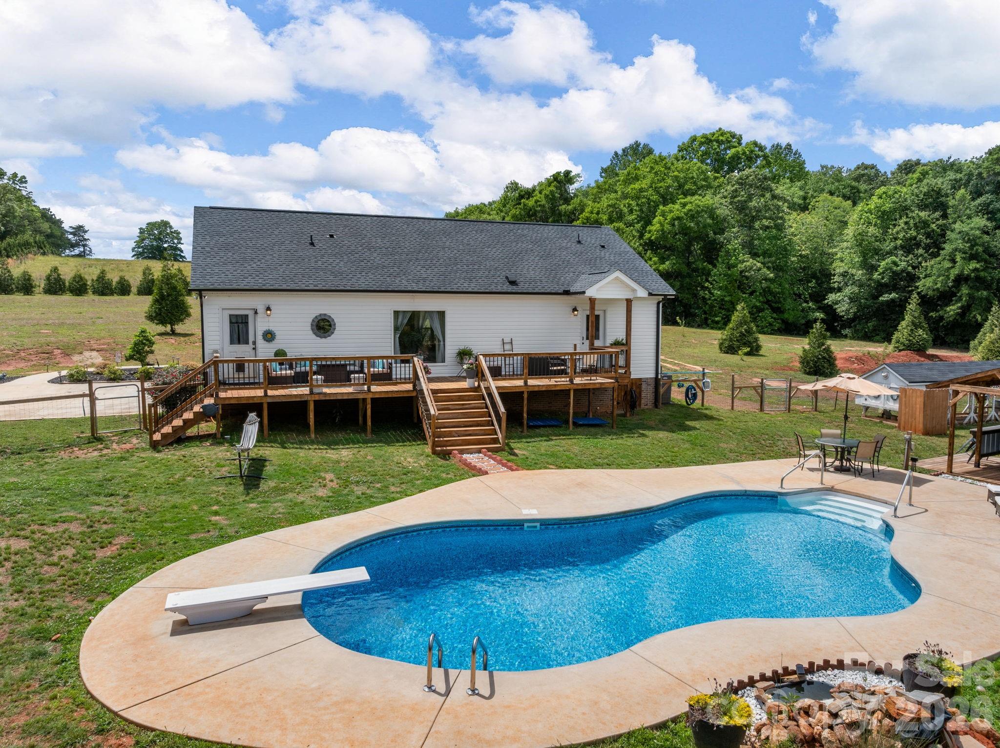 1076 McSwain Road Chesnee, SC 29323 - Photo 30 of 36 swimming pool view with a seating space and a garden