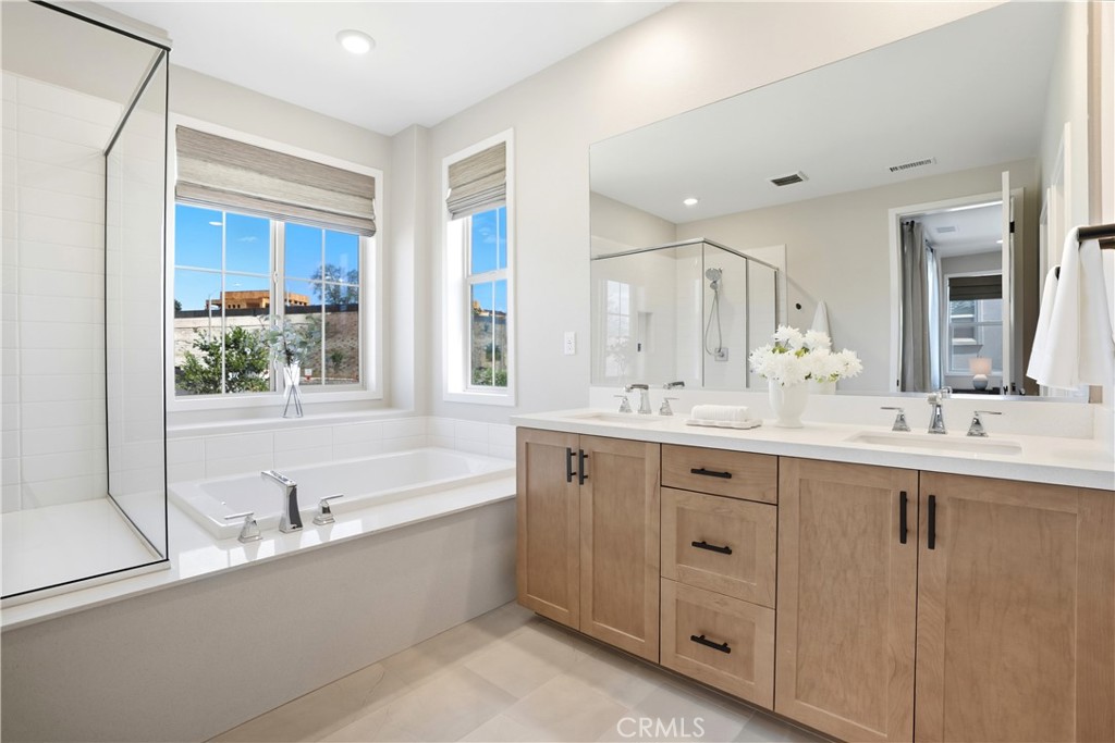 1341 Roots Way Rancho Mission Viejo, CA 92694 - Photo 30 of 75 a bathroom with a sink double vanity mirror and a bathtub