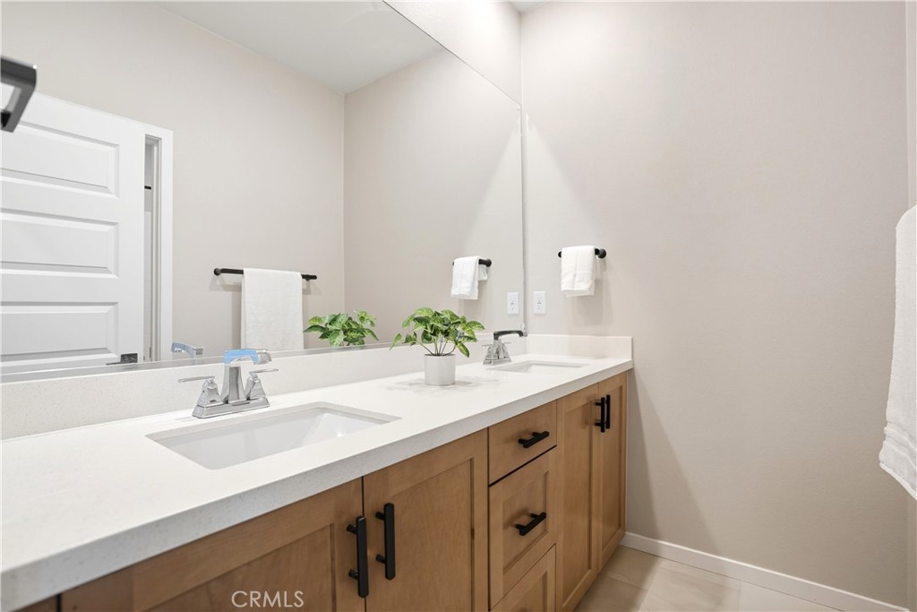 1341 Roots Way Rancho Mission Viejo, CA 92694 - Photo 39 of 75 a bathroom with a sink and a mirror