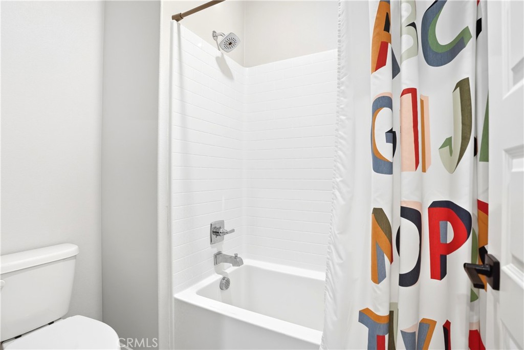 1341 Roots Way Rancho Mission Viejo, CA 92694 - Photo 40 of 75 a bathroom with a bathtub and shower curtain