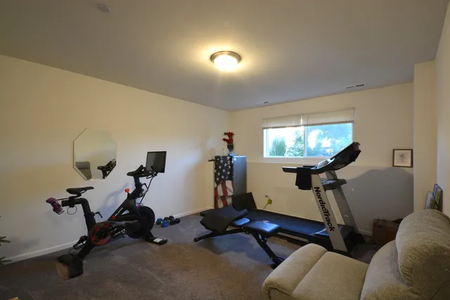 a room with gym equipment and a mirror