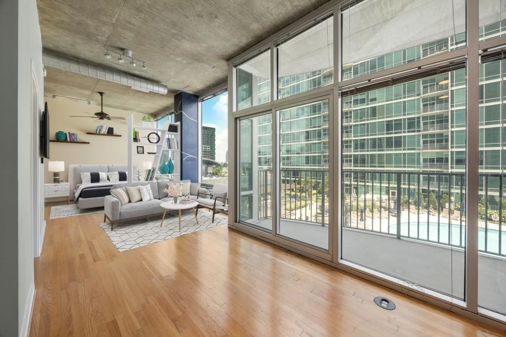 923 Peachtree Street Northeast, Unit 932 Atlanta, GA 30309 - Photo 11 of 69 a living room with furniture and a large window