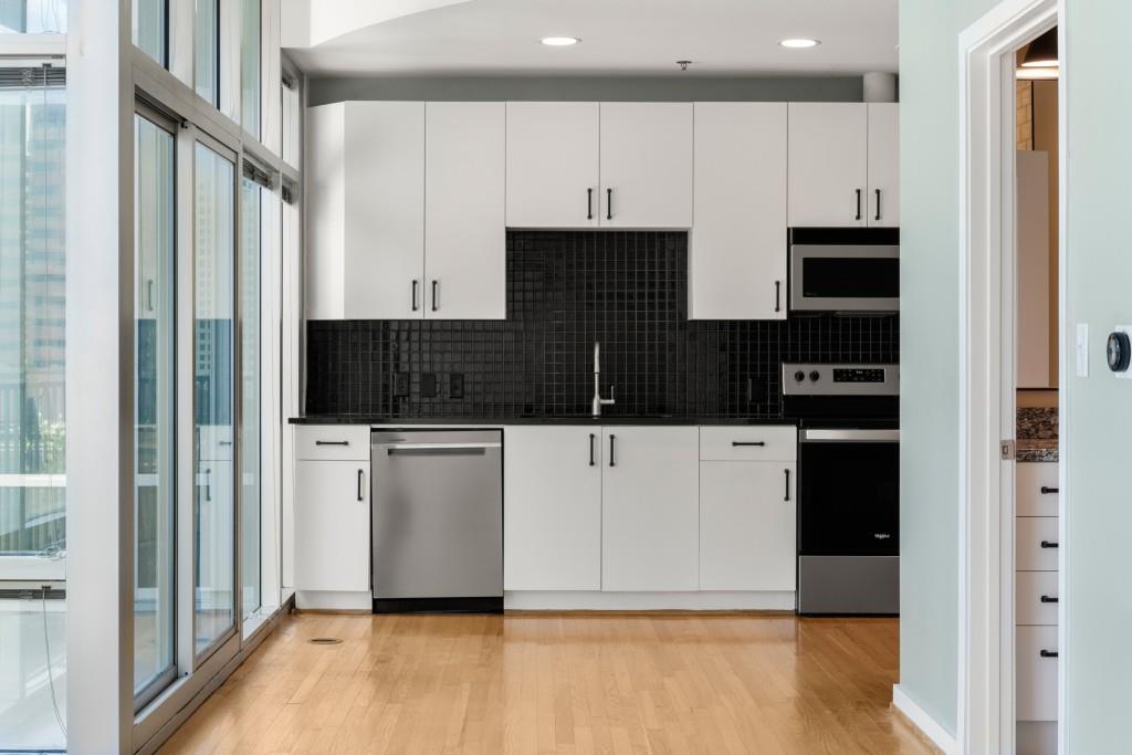 923 Peachtree Street Northeast, Unit 932 Atlanta, GA 30309 - Photo 16 of 69 a view of kitchen with stainless steel appliances wooden floor and cabinets
