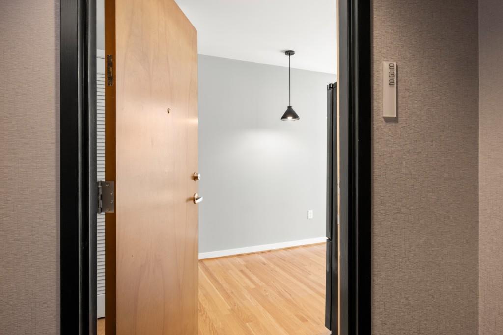 923 Peachtree Street Northeast, Unit 932 Atlanta, GA 30309 - Photo 3 of 69 a view of a hallway with wooden floor and a bathroom