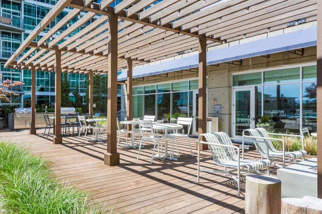 923 Peachtree Street Northeast, Unit 932 Atlanta, GA 30309 - Photo 40 of 69 a view of a patio with a dining table chairs and floor to ceiling window