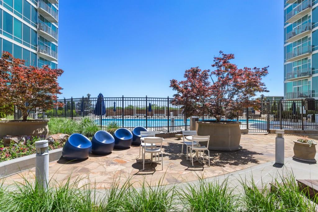 923 Peachtree Street Northeast, Unit 932 Atlanta, GA 30309 - Photo 50 of 69 a view of a patio with couches table and chairs and potted plants