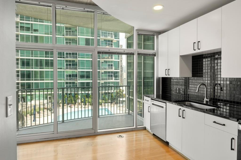 923 Peachtree Street Northeast, Unit 932 Atlanta, GA 30309 - Photo 5 of 69 a kitchen with a sink a microwave and cabinets
