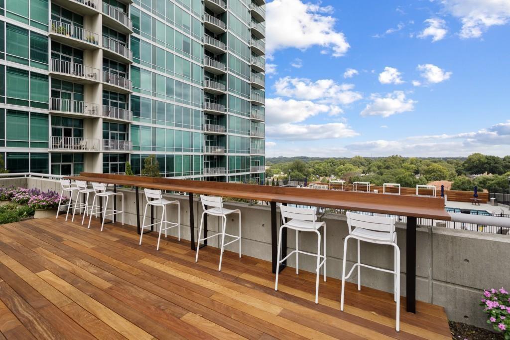 923 Peachtree Street Northeast, Unit 932 Atlanta, GA 30309 - Photo 60 of 69 a view of a balcony with furniture and city view