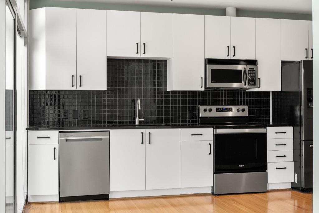923 Peachtree Street Northeast, Unit 932 Atlanta, GA 30309 - Photo 6 of 69 a kitchen with stainless steel appliances a stove microwave and cabinets