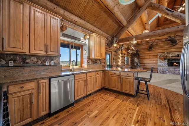 a kitchen with cabinets and wooden floor