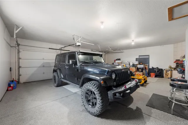 a garage with a bike and car