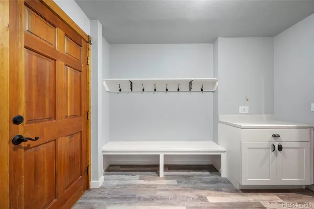 a view of room with wooden floor and cabinet