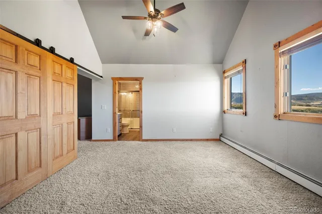 an empty room with windows and cabinet