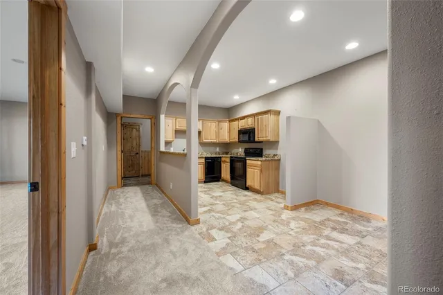 a view of kitchen with refrigerator and microwave