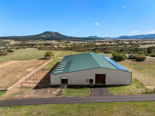 a aerial view of a house with a yard
