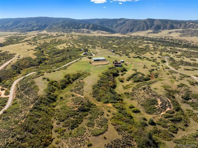 a large bed sitting in a room next to a window