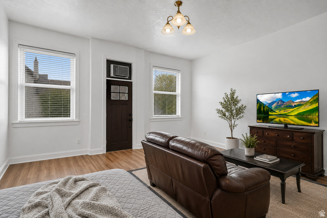 69 South Main Street Manti, UT 84642 - Photo 18 of 44 Bright living area featuring wood-finish flooring, white trim, and light-colored walls