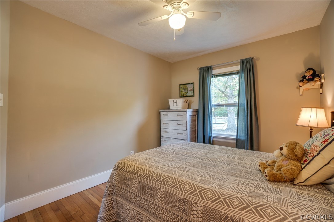 8445 Stumpy Road Hanover, VA 23069 - Photo 17 of 49 a bedroom with a bed and a chandelier