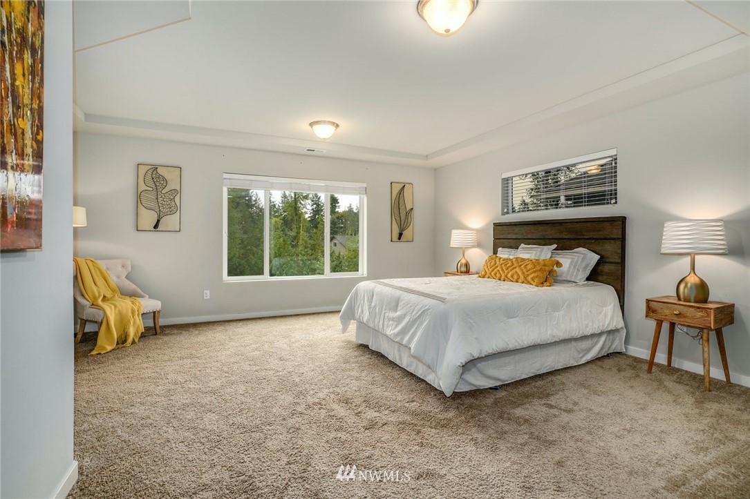 15809 Meridian Avenue South Bothell, WA 98012 - Photo 14 of 32 a bedroom with a bed and a window