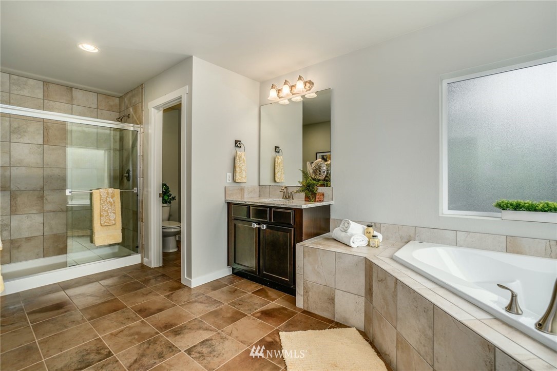 15809 Meridian Avenue South Bothell, WA 98012 - Photo 17 of 32 a bathroom with a tub sink and mirror