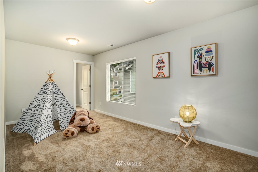 15809 Meridian Avenue South Bothell, WA 98012 - Photo 21 of 32 a view of a bedroom with baby bed and lounge chair