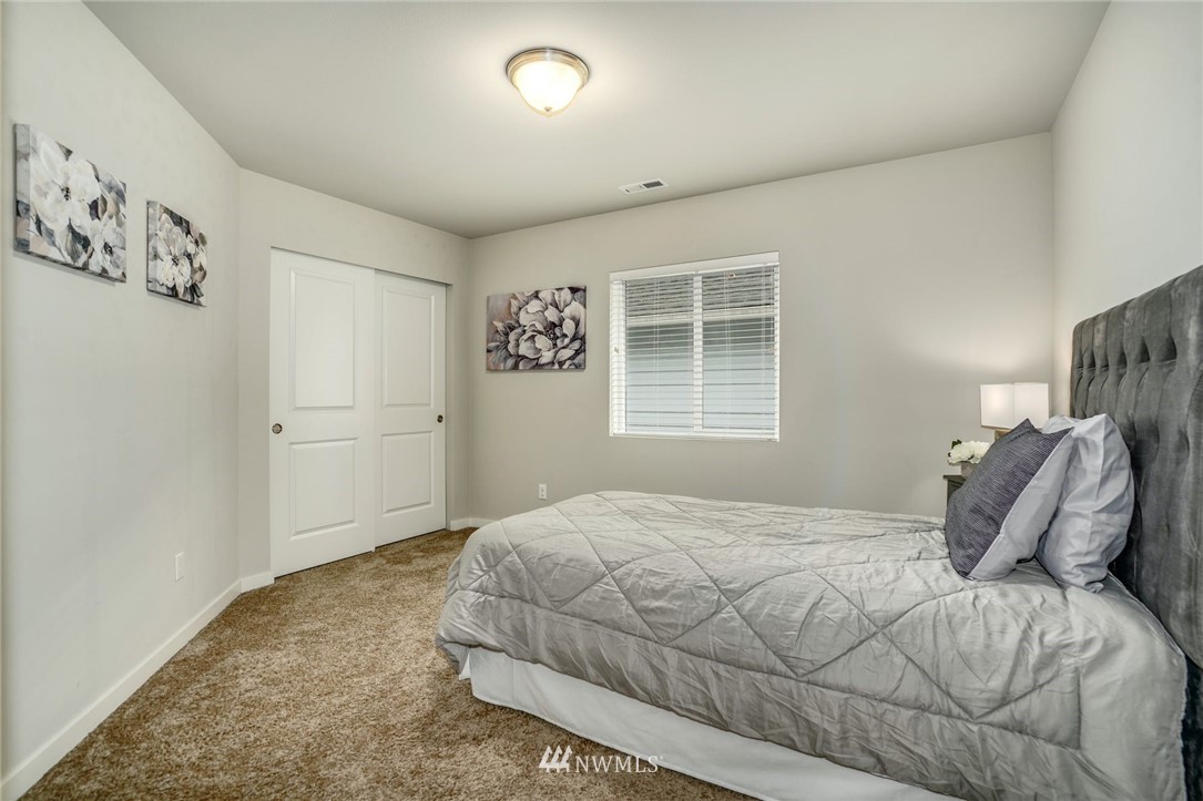 15809 Meridian Avenue South Bothell, WA 98012 - Photo 23 of 32 a bedroom with a bed and a window