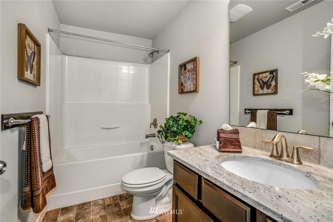 15809 Meridian Avenue South Bothell, WA 98012 - Photo 24 of 32 a bathroom with a granite countertop toilet sink and bathtub