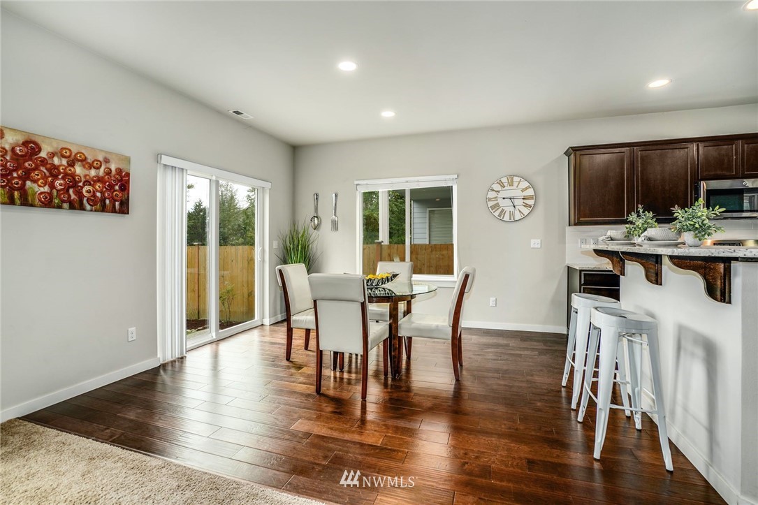 15809 Meridian Avenue South Bothell, WA 98012 - Photo 7 of 32 a view of a dining room with furniture and wooden floor