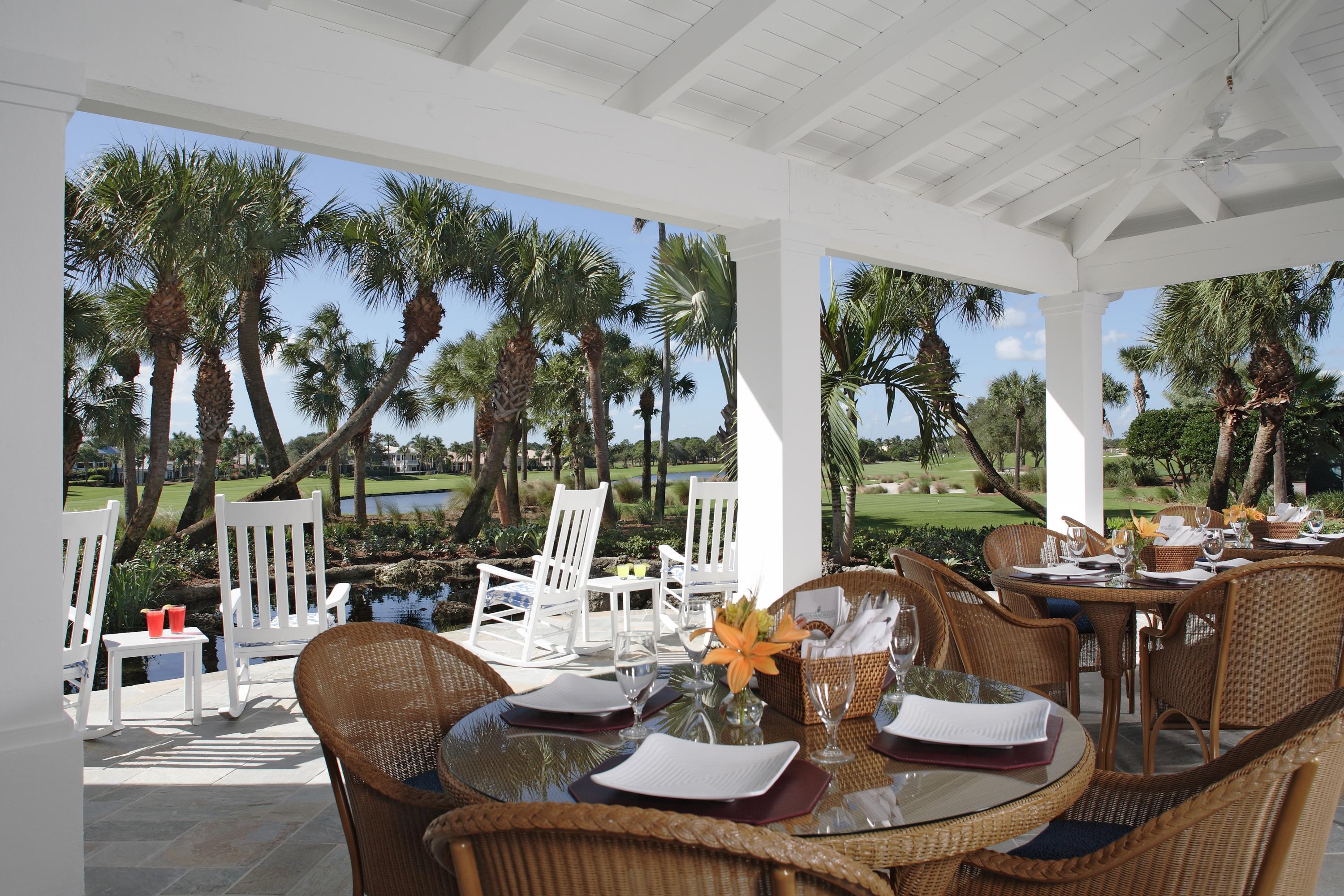 108 Micco Circle Jupiter, FL 33458 - Photo 18 of 20 a dining room with furniture a large window and palm tree