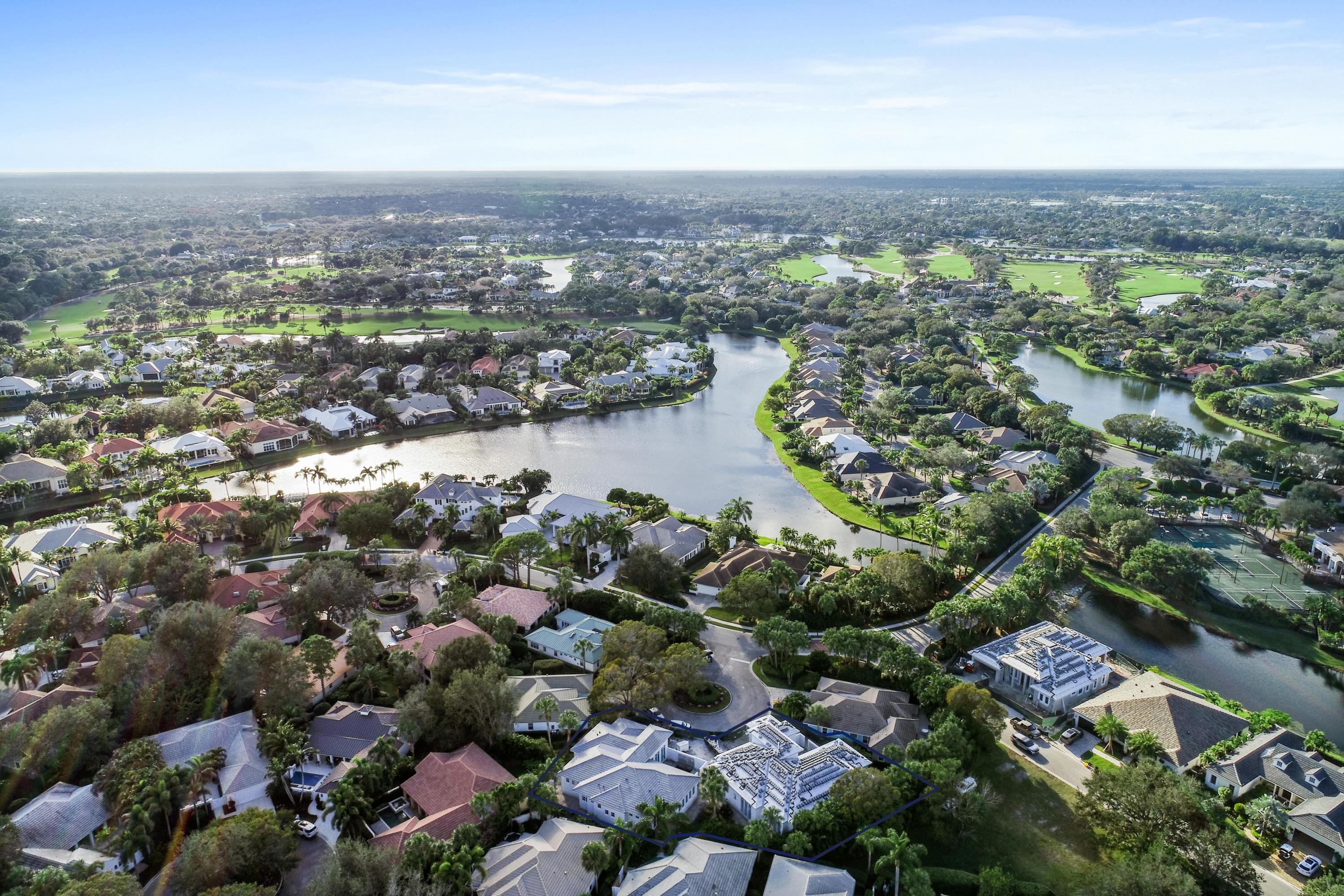 108 Micco Circle Jupiter, FL 33458 - Photo 4 of 20 an aerial view of a city with lots of residential buildings and mountain view in back