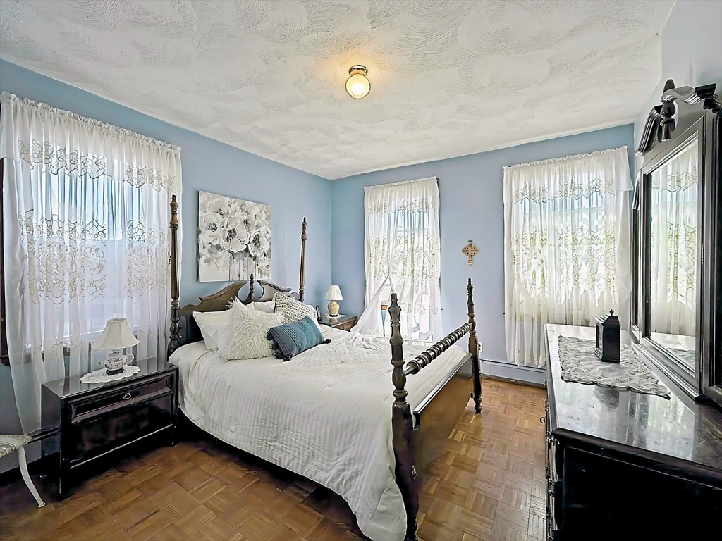 20 Locust Street Everett, MA 02149 - Photo 19 of 39 a bedroom with a bed and wooden floor