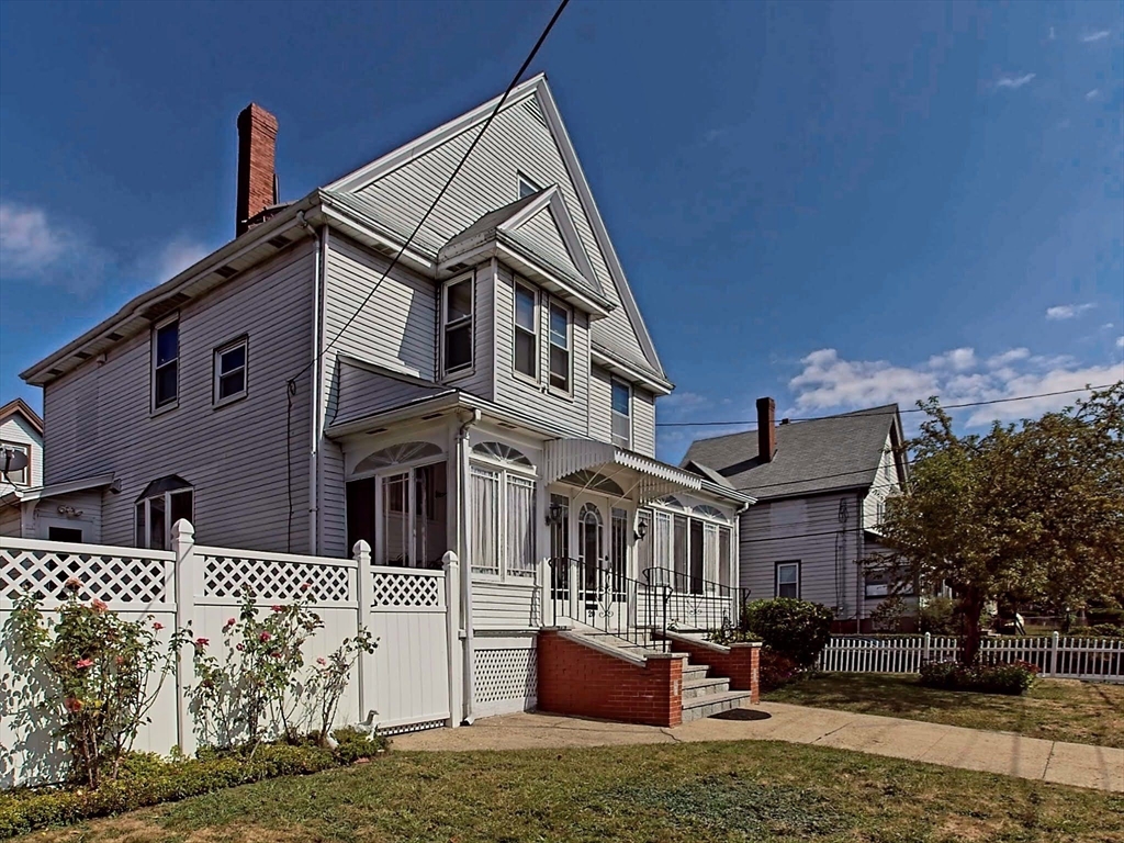 20 Locust Street Everett, MA 02149 - Photo 2 of 39 a front view of a house with a yard