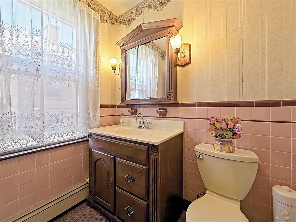 20 Locust Street Everett, MA 02149 - Photo 21 of 39 a bathroom with a toilet sink and mirror