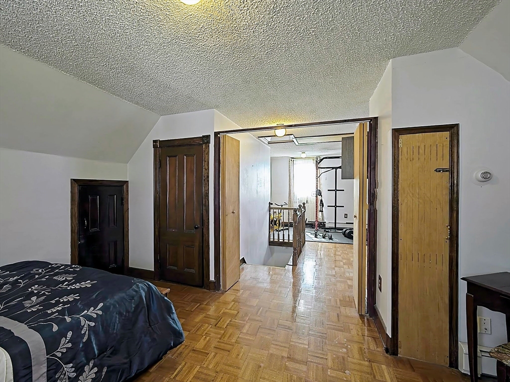 20 Locust Street Everett, MA 02149 - Photo 22 of 39 a bedroom with a bed and a large mirror