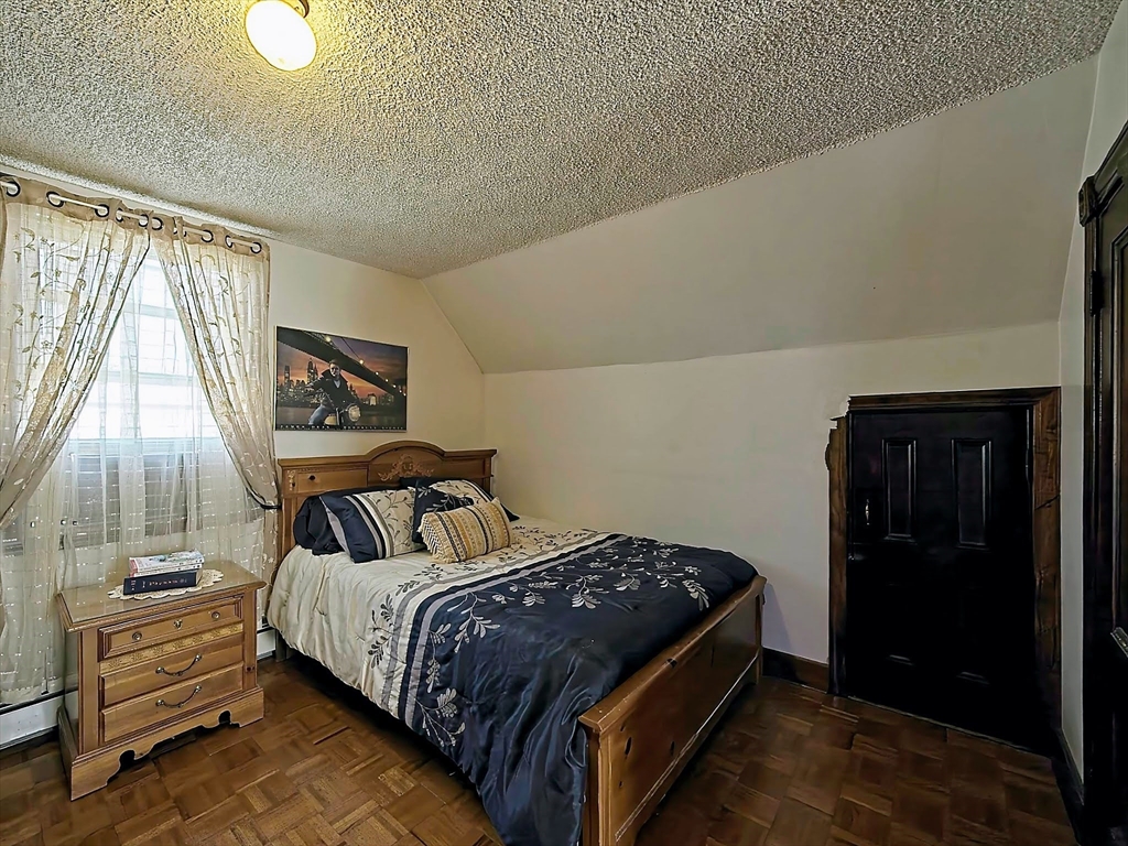 20 Locust Street Everett, MA 02149 - Photo 23 of 39 a bedroom with a bed and a window