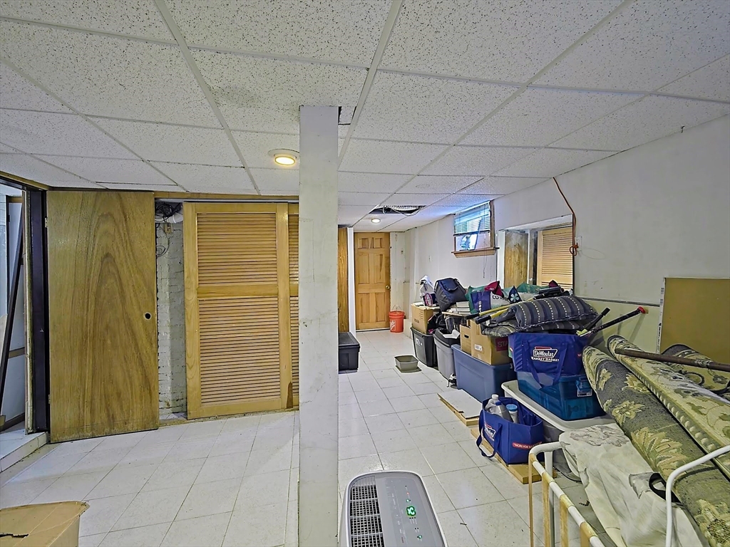 20 Locust Street Everett, MA 02149 - Photo 24 of 39 a view of a livingroom with furniture and gym equipment