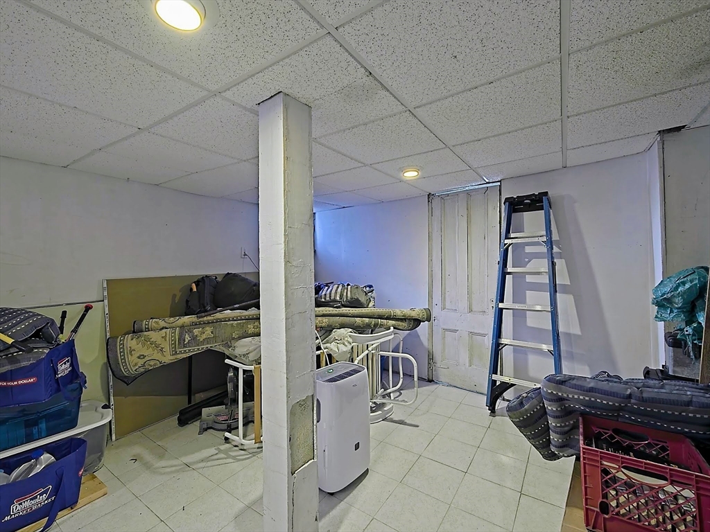20 Locust Street Everett, MA 02149 - Photo 25 of 39 a kitchen that has a stove and a table in it