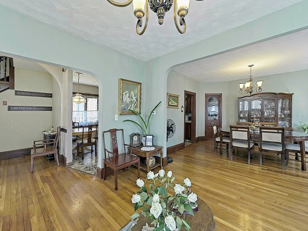 20 Locust Street Everett, MA 02149 - Photo 6 of 39 a living room with furniture dining table and a wooden floor