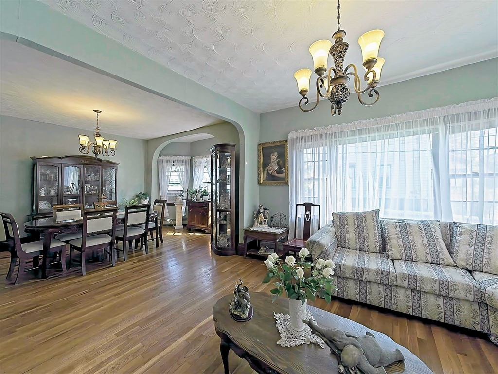 20 Locust Street Everett, MA 02149 - Photo 8 of 39 a living room with furniture chandelier and wooden floor