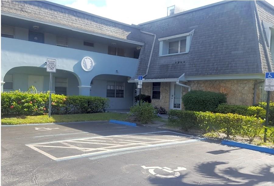 a front view of a house with a yard and a garage
