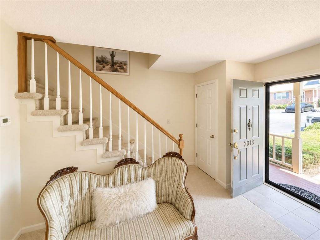 2018 Cardinal Park Drive Anderson, SC 29621 - Photo 4 of 11 Enter into a welcoming interior with a carpeted staircase, connecting living spaces with ease.