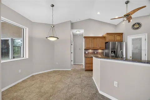 a view of a kitchen with center island and stainless steel appliances