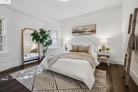 a bed sitting in a bedroom next to a window