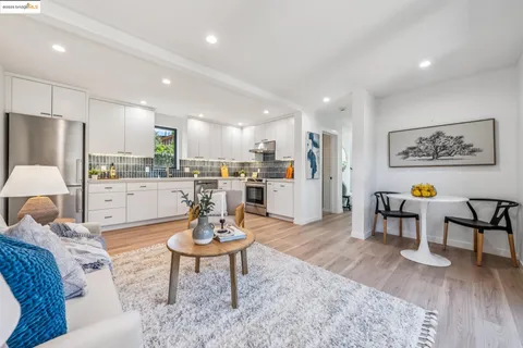 a kitchen with a sink a stove and cabinets